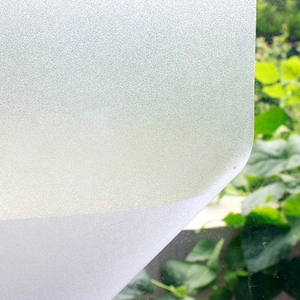 Close-up of frosted window film texture on glass showing privacy screening and translucency