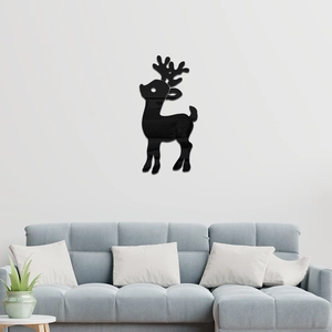 Modern black mirror deer wall sticker placed above a sofa in a minimalist living room décor