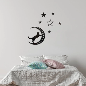 Detail view of glossy black acrylic cat and moon wall sticker on a bedroom background wall
