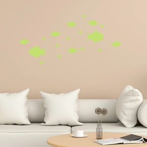 Luminous fish wall stickers set displayed above a white sofa in a modern room