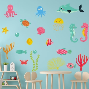 Detail showing a colorful cartoon sea creature wall sticker set in a cozy nursery room