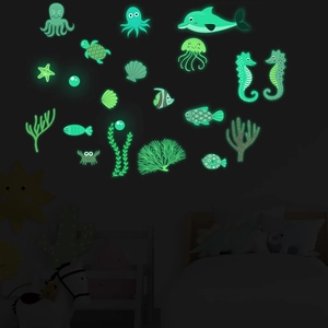 Detailed view of luminous ocean animal wall stickers glowing green in a dark kids room