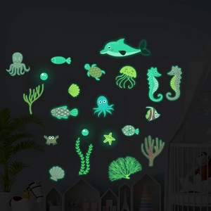 Luminous marine life wall stickers glowing green in a dark children's bedroom setting