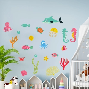 Detailed wall scene showing cartoon ocean animal stickers on a blue nursery wall