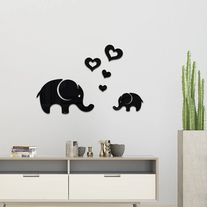 Detail view of black acrylic elephant and heart mirror wall stickers on a white wall