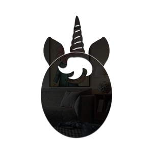 Macro shot of 3D acrylic unicorn mirror wall sticker reflecting a modern living room