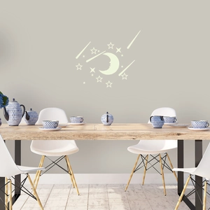 Glow-in-the-dark moon and stars wall stickers applied on a modern grey bedroom wall