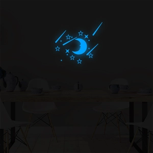 Luminous blue moon and stars wall stickers glowing in a dark bedroom at night