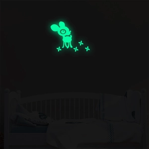 Glow-in-the-dark deer wall sticker set illuminating a child's bedroom wall at night