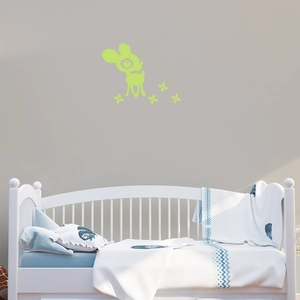Glow-in-the-dark cute deer and flower wall stickers above a child's bed in a bedroom