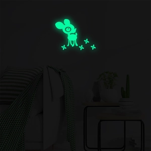 Glow in the dark cartoon deer wall decals emitting green light in a dark nursery room