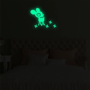 Luminous cartoon deer and flower wall stickers glowing bright green in the dark bedroom