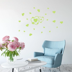 Detail of glow in the dark heart wall stickers in a cozy white living room setting