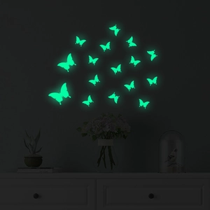Luminous green butterfly wall stickers glowing in a dark bedroom setting, 16 pieces set