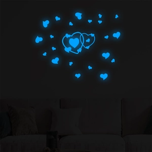 Stickers muraux cœurs bleus lumineux avec effet fluorescent au-dessus d'un canapé