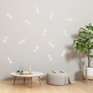 Detailed view of luminous key wall stickers glowing in a modern minimalist bedroom setting