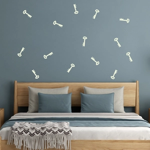 Luminous blue key wall stickers glowing on dark bedroom walls for creative home decor