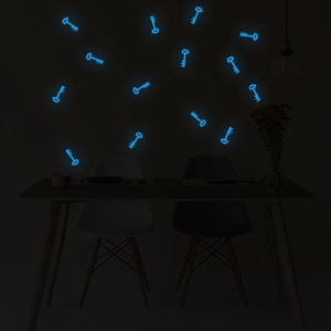 Luminous blue key-shaped wall stickers glowing in a dark room setting with home decor