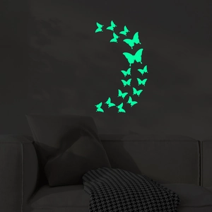 Luminous butterfly wall stickers set showing glowing green wing designs on dark wall