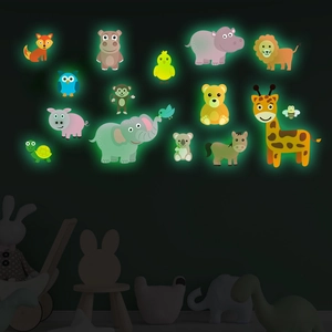 Detail of 14 cartoon animal glow-in-the-dark wall stickers showing green fluorescence in dark