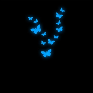 Close-up of luminous blue butterfly wall stickers glowing brightly in a dark room