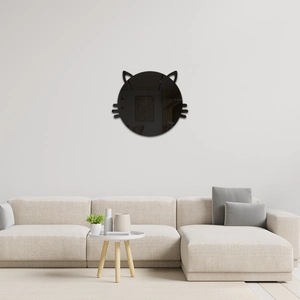 Detail of cat shaped acrylic mirror wall sticker above a modern sofa in a living room