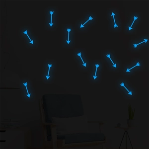 Glow-in-the-dark blue arrow wall stickers in a dark room setting with furniture