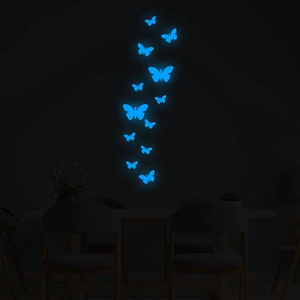 Detailed blue fluorescent butterfly wall stickers glowing in a dark room setting