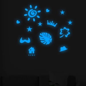 Macro detail of ice blue glowing wall stickers with sun star and home shapes in the dark