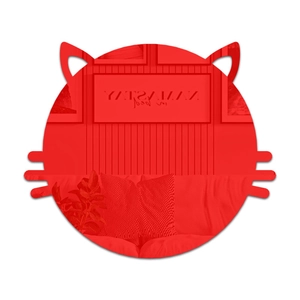 Macro detail of red acrylic cat mirror wall sticker reflecting modern living room interior