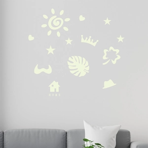 Detailed view of luminous wall stickers with sun and heart patterns on gray wall