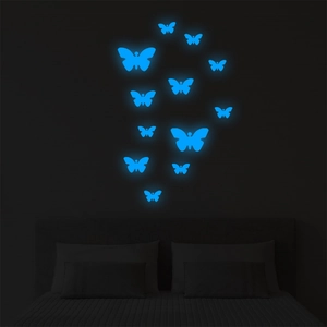 Luminous blue butterfly wall stickers glowing in a dark bedroom setting