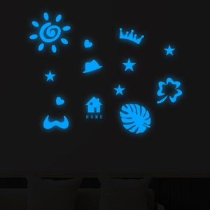 Glow-in-the-dark blue wall stickers showing luminous home and star icons in the dark
