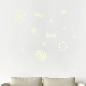 Luminous wall sticker set featuring sun, stars, and leaves above a sofa for home decor