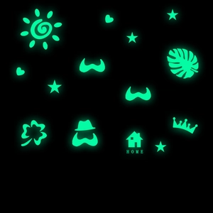 Luminous wall stickers set showing glowing stars and hearts in dark bedroom environment
