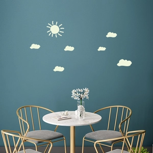 Luminous wall stickers featuring a cute sun and clouds design in a modern room setting