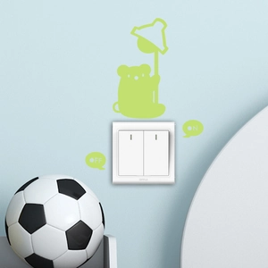 Luminous bear wall sticker on a blue wall with glowing ON/OFF switch indicators