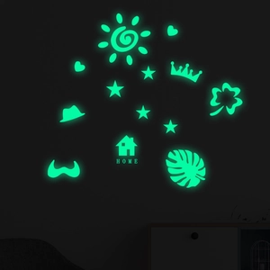 Luminous wall stickers set with glowing stars and home silhouette in dark room decor