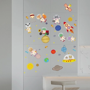Detail view of cartoon animal astronaut wall stickers applied on a modern grey tiled wall