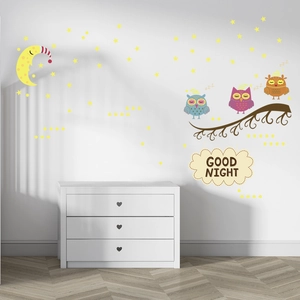 Luminous wall stickers with cartoon owls and moon glowing in a cozy nursery room