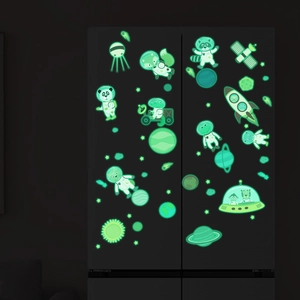 Glow-in-the-dark space stickers featuring cartoon animals on a black refrigerator