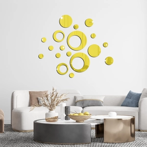 Detailed view of golden mirror circle wall stickers reflecting light in a modern living room