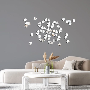 Macro view of silver acrylic heart mirror wall stickers arranged in a floral DIY pattern