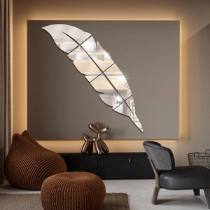 Macro detail of feather mirror wall sticker showing acrylic material on dark background