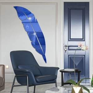 Macro detail of large blue acrylic mirror feather wall sticker in modern living room setting