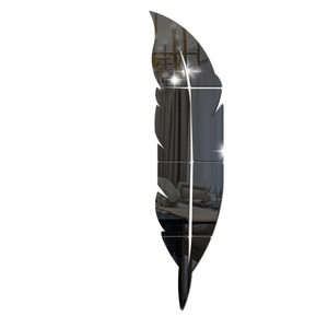 Detail of feather-shaped acrylic mirror wall stickers showing high reflective dark finish