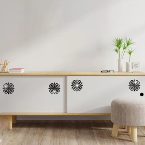 Detail of 3D black floral acrylic mirror wall stickers on a modern white cabinet door