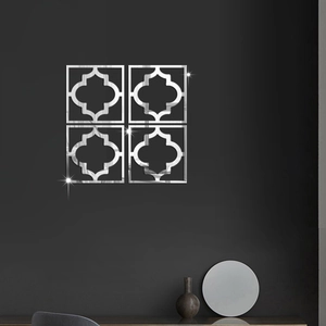 Close-up of four-piece hollow clover mirror wall stickers on a dark gray indoor wall