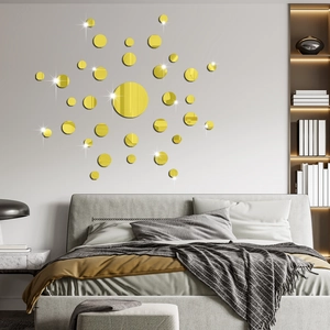 Detail of round gold mirror wall stickers in various sizes for modern bedroom decor