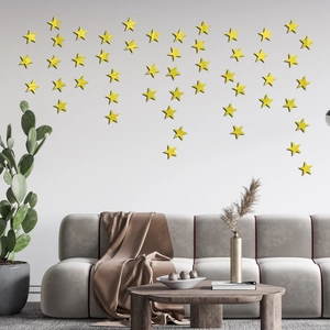 Detailed view of yellow 3D star wall decals with reflective mirror finish in a modern living room